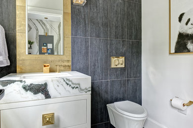 Inspiration for a mid-sized transitional 3/4 bathroom in New York with white cabinets, a wall-mount toilet, black tile, gray tile, porcelain tile, white walls, mosaic tile floors, an undermount sink, marble benchtops, white benchtops, multi-coloured floor and flat-panel cabinets.