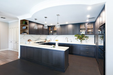 Design ideas for a small contemporary u-shaped kitchen in Sydney with an undermount sink, shaker cabinets, blue cabinets, porcelain splashback, black appliances, porcelain floors, a peninsula and black floor.