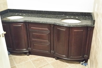Inspiration for a contemporary beige tile and stone tile travertine floor sauna remodel in Detroit with an undermount sink, furniture-like cabinets, dark wood cabinets, granite countertops, a two-piece toilet and beige walls