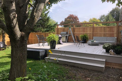 This is an example of a mid-sized contemporary backyard deck in Ottawa with no cover.