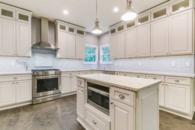 Mid-sized trendy l-shaped medium tone wood floor open concept kitchen photo in Milwaukee with an undermount sink, raised-panel cabinets, white cabinets, quartz countertops, white backsplash, subway tile backsplash, stainless steel appliances and an island