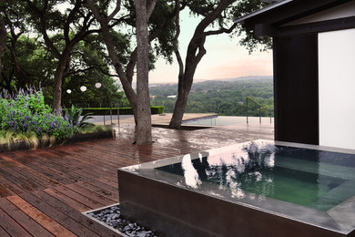 This is an example of a large modern backyard landscaping in Austin.