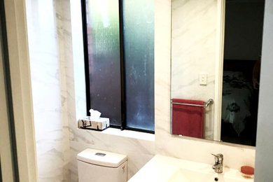 Bathroom - small modern master ceramic tile ceramic tile and multicolored floor bathroom idea in Perth with beaded inset cabinets, white cabinets, a wall-mount toilet, multicolored walls, a drop-in sink, a hinged shower door and white countertops