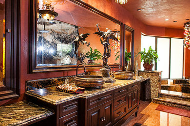 Inspiration for a large mediterranean master ceramic tile and orange floor corner shower remodel in Seattle with furniture-like cabinets, dark wood cabinets, a hot tub, orange walls, a vessel sink, granite countertops and a hinged shower door