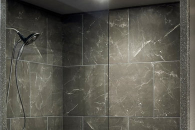Large minimalist master porcelain tile and multicolored floor bathroom photo in Los Angeles with flat-panel cabinets, gray cabinets, a one-piece toilet, gray walls, quartzite countertops and gray countertops