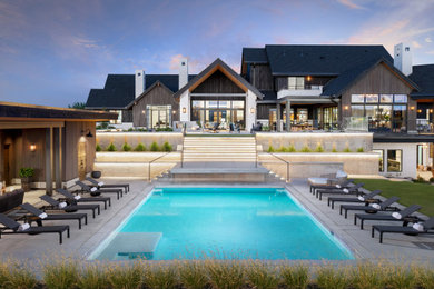 Example of a huge transitional backyard concrete and rectangular pool design in Denver