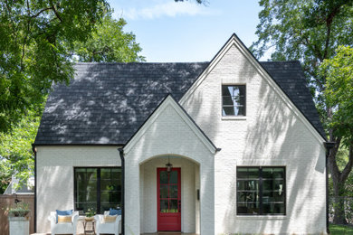 Example of a mid-sized transitional white two-story brick and clapboard exterior home design in Austin with a shingle roof and a gray roof