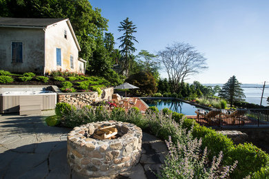 Design ideas for a traditional backyard stone landscaping in New York.