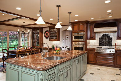 Inspiration for a large timeless l-shaped ceramic tile eat-in kitchen remodel in San Francisco with raised-panel cabinets, beige backsplash, an undermount sink, medium tone wood cabinets, granite countertops, ceramic backsplash, paneled appliances and an island
