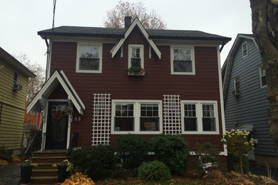 Mid-sized elegant red two-story concrete fiberboard gable roof photo in New York