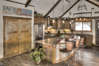 Inspiration for a large country l-shaped open plan kitchen in Minneapolis with an undermount sink, recessed-panel cabinets, dark wood cabinets, quartzite benchtops, beige splashback, stainless steel appliances, medium hardwood floors and with island.