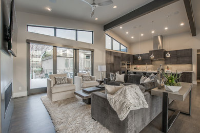 Large trendy open concept dark wood floor living room photo in Denver with gray walls and a wall-mounted tv