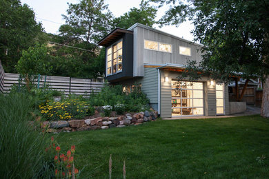 Example of an urban multicolored two-story wood exterior home design in Denver with a shed roof and a metal roof