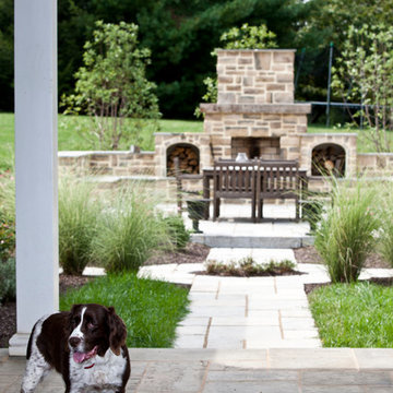 View of outdoor fireplace and patio from the breezeway