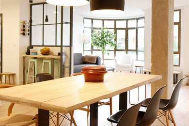 Photo of a large industrial open plan dining in Madrid with white walls, medium hardwood floors and no fireplace.