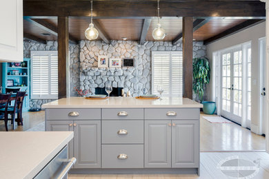 Kitchen pantry - transitional kitchen pantry idea in Los Angeles with a farmhouse sink, recessed-panel cabinets, gray cabinets, quartz countertops, blue backsplash, subway tile backsplash, stainless steel appliances and an island
