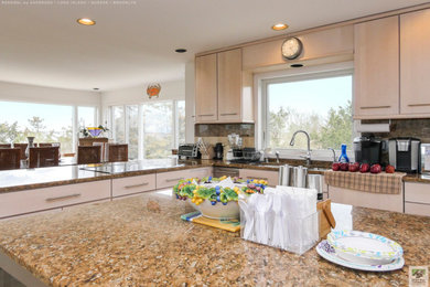 Eat-in kitchen - large u-shaped light wood floor eat-in kitchen idea in New York with an undermount sink, flat-panel cabinets, light wood cabinets, granite countertops, multicolored backsplash, granite backsplash, stainless steel appliances, an island and multicolored countertops