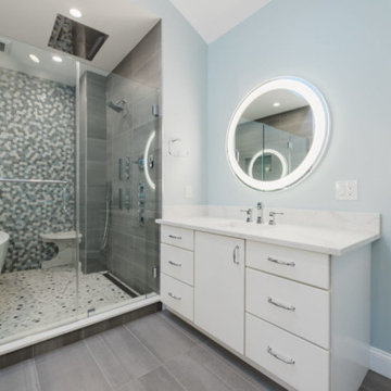 Bath Sanctuary: Freestanding Tub, Glass Door, White Cabinets, LED Mirror