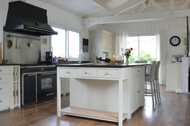 Inspiration for a large country open plan kitchen in Nantes with medium hardwood floors.