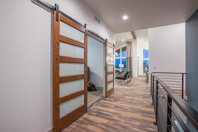 Mid-sized trendy medium tone wood floor and brown floor foyer photo in Denver with gray walls