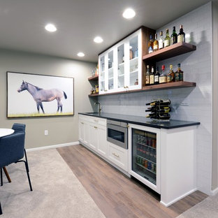 Large modern look-out basement in Other with grey walls, carpet, a two-sided fireplace, a wooden fireplace surround and beige floors.