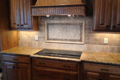 Mid-sized elegant l-shaped dark wood floor and brown floor open concept kitchen photo in Wichita with an undermount sink, raised-panel cabinets, dark wood cabinets, granite countertops, beige backsplash, ceramic backsplash, stainless steel appliances and no island