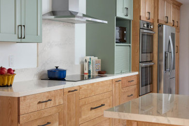 Inspiration for a mid-sized transitional galley porcelain tile and green floor eat-in kitchen remodel in San Francisco with a single-bowl sink, shaker cabinets, green cabinets, quartz countertops, green backsplash, quartz backsplash, stainless steel appliances, a peninsula and green countertops