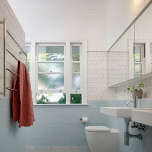 Design ideas for a mid-sized contemporary master bathroom in Brisbane with an open shower, blue tile, white walls, a wall-mount sink, tile benchtops, grey floor, a hinged shower door, white benchtops and a double vanity.