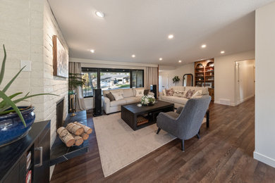 Inspiration for a mid-sized transitional enclosed vinyl floor and brown floor living room remodel in Edmonton with white walls, a ribbon fireplace and no tv