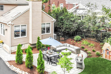Design ideas for a small traditional backyard concrete paver retaining wall landscape in Other.