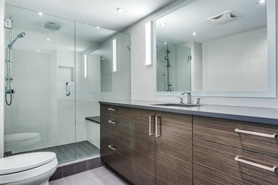 Minimalist gray tile and cement tile ceramic tile bathroom photo in Vancouver with flat-panel cabinets, gray cabinets, a one-piece toilet, gray walls, an undermount sink and quartzite countertops