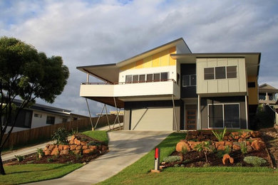 Photo of a contemporary house exterior in Gold Coast - Tweed with a metal roof.