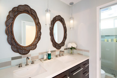 Example of a trendy master blue tile and glass tile bathroom design in Los Angeles with an undermount sink, dark wood cabinets, blue walls and quartzite countertops