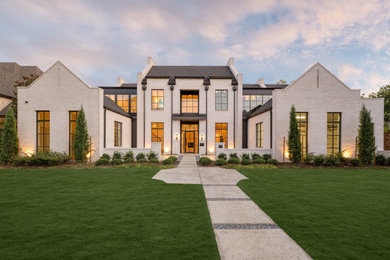 Transitional gray two-story brick exterior home idea in Dallas