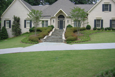 Photo of a mid-sized traditional stucco beige exterior in Atlanta.