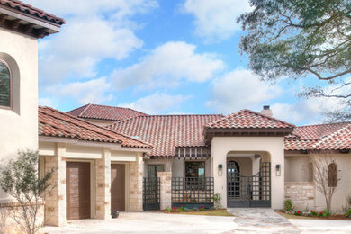 Inspiration for a huge beige two-story exterior home remodel in Austin