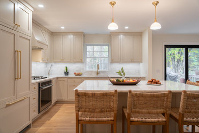 Kitchen - kitchen idea in New York with shaker cabinets, beige cabinets and an island