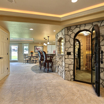 Open Basement Concept in Centennial, CO with tray ceilings and stacked stone