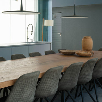 Birre dining room with wood table, dark chairs and pendant lights