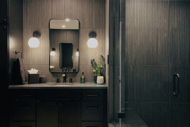 Large minimalist master black tile and ceramic tile porcelain tile, beige floor and double-sink bathroom photo in Other with shaker cabinets, black cabinets, a bidet, green walls, an undermount sink, granite countertops, a hinged shower door, black countertops and a floating vanity