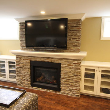 Basement recreation room with new stone fireplace and built-ins