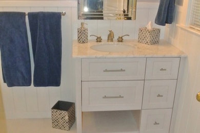 Inspiration for a mid-sized transitional master white tile and ceramic tile porcelain tile corner shower remodel in Other with an undermount sink, recessed-panel cabinets, white cabinets, marble countertops, a one-piece toilet and gray walls