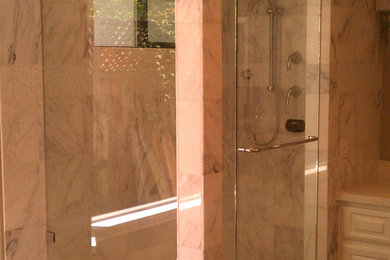 Inspiration for a mid-sized transitional master corner shower remodel in San Francisco with a hinged shower door