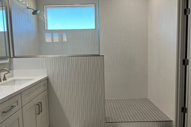 Bathroom - large modern master white tile and porcelain tile double-sink bathroom idea in Phoenix with shaker cabinets, white cabinets, an undermount sink, quartz countertops, white countertops and a built-in vanity