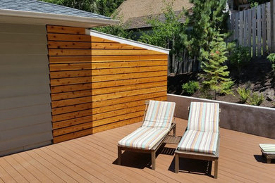 Example of a small trendy gray one-story wood exterior home design in Portland