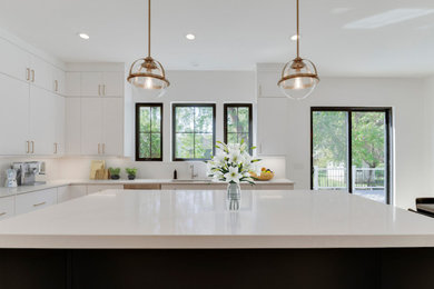 Mid-sized trendy l-shaped kitchen photo in Other with an undermount sink, flat-panel cabinets, white cabinets, stainless steel appliances, an island and white countertops