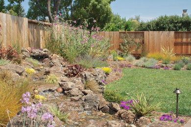 Photo of a large traditional full sun and drought-tolerant backyard concrete paver landscaping in San Francisco.