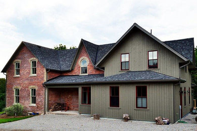 Country green two-story wood gable roof photo in Toronto
