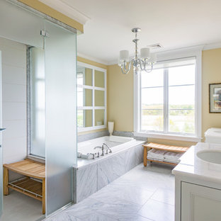 Example of a transitional yellow tile gray floor bathroom design in Phoenix with yellow walls, an undermount sink and a hinged shower door