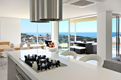 Photo of a contemporary kitchen in Sydney with white cabinets, marble benchtops and with island.